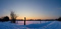 Sunset over a field in snow Royalty Free Stock Photo