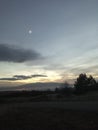 Sunset over the fields. Moon above.