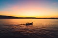 Sunset over fishing boat and shining golden sea water Royalty Free Stock Photo