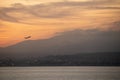 Sunset over the flying plane in the mediterranean sea in Nice, France Royalty Free Stock Photo