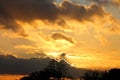 Sunset over the forest.Bright clouds,golden rays,dark clouds.