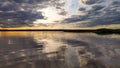 Sunset over the forest lake. View from the boat, image in the orange-purple toning.Nature in twilight period. Photo