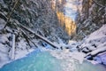Sunset over frozen creek in Sucha Bela gorge in Slovak Paradise during winter Royalty Free Stock Photo