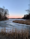 Sunset over frozen lake in early spring Royalty Free Stock Photo