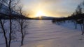 Sunset over a frozen snowy lake