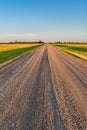 Sunset over a gravel road on the Saskatchewan prairies Royalty Free Stock Photo
