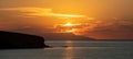 Sunset over Greek island, Cyclades, Greece. Golden sun hides behind cloud. Sparkle sea. Banner Royalty Free Stock Photo