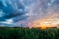 Sunset over green field with road Royalty Free Stock Photo