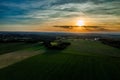 Sunset over green fields and village terrain. View from. Royalty Free Stock Photo