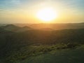 Sunset over green hills landscape Royalty Free Stock Photo