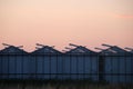 Sunset over a greenhouse with roses in Moerkapelle where windows are open to cool the roses.