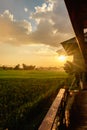 Sunset over the greeny farmland at the old wooden farmland, Sunbeams through the cloud as a sunset