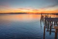 Sunset over the Gulf of Mexico with an old pier Royalty Free Stock Photo