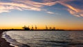 Sunset over harbor in Gdansk with commercial dock and cranes Royalty Free Stock Photo