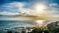 Sunset over the horizon with a few clouds on the rocky shores Paradise Cove Royalty Free Stock Photo