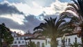 Sunset over houses and palms in Funchal, Madeira, Portugal timelapse Royalty Free Stock Photo