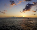 the sunset over the Indian ocean in Reunion and one isolated boat sailing island Royalty Free Stock Photo