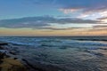 Sunset over the Indian Ocean. Turquoise waves run to the sandy shore. Royalty Free Stock Photo