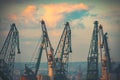 Sunset over industrial cranes at commercial sea port of the city of Varna, Bulgaria Royalty Free Stock Photo