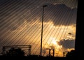 Sunset over industrial part of town - seen through suspension cables