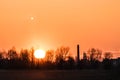 Sunset over the industrial zone, moon.