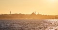 Sunset over Istanbul Silhouette wih City line ferry and boats. Traditional arabic town with silhouettes of minarets on sunset, Royalty Free Stock Photo