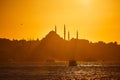 Sunset over Istanbul Silhouette wih City line ferry and boats. Traditional arabic town with silhouettes of minarets on sunset, Royalty Free Stock Photo