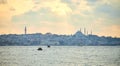 Sunset over Istanbul with a view of the Suleymaniye  Mosque and City line ferry and boats. Traditional arabic town with Royalty Free Stock Photo