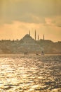 Sunset over Istanbul with a view of the Suleymaniye  Mosque and City line ferry and boats. Traditional arabic town with Royalty Free Stock Photo