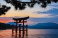 Sunset over the Japanese traditional red Torii gate shrine standing in the river of Itsukushima Royalty Free Stock Photo