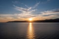 Sunset over Koufonisia island silhouette, Cyclades, Greece. Sunbeam paints gold Aegean calm sea Royalty Free Stock Photo