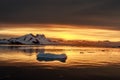 Sunset over the lagoon with drifting icebergs and snow mountains in the background, Lemaire Channel