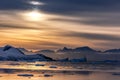 Sunset over the lagoon with drifting icebergs and snow mountains Royalty Free Stock Photo
