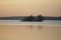 Sunset over the lake in April. Quiet warm clear evening and ducks above the water Royalty Free Stock Photo