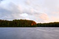 Sunset over the lake in the background of the forest. Royalty Free Stock Photo