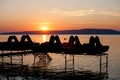 Sunset over Lake Balaton with silhouettes of paddle boats Royalty Free Stock Photo