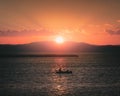 Sunset over Lake Champlain taken from Burlington, Vermont with a small boat center frame Royalty Free Stock Photo