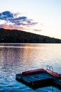 Sunset over lake with dock and canoes during Indian Summer in Quebec, Canada