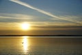 Sunset over the lake in October. Quiet clear evening. Expanse horizon reflection