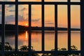 Sunset over a lake, sky. Lattice. Prison. Royalty Free Stock Photo