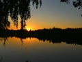 Sunset over the lake with tree leaves Royalty Free Stock Photo