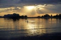 Sunset over the lake on a warm summer day. June sky and beautiful clouds. Horizon and reflection.