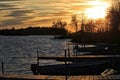 Sunset over large lake and docks jutting into water located in Hayward, Wisconsin Royalty Free Stock Photo