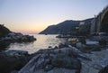 sunset over the Ligurian sea, cliffs, and boats on the waves in Framura, Italy. Marina at dusk Royalty Free Stock Photo