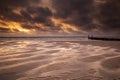 Sunset over low tide beach at North sea Royalty Free Stock Photo