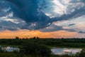 sunset over a meadow and a pond Royalty Free Stock Photo