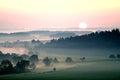 Sunset over misty landscape