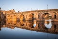 Sunset over the monument, Roman bridge over the Guadiana River in Merida, Spain Royalty Free Stock Photo