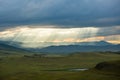 Sunset over the mountain landscape. A beautiful sun rays with clouds. Republic Of Khakassia, Russia. Royalty Free Stock Photo