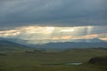Sunset over the mountain landscape. A beautiful sun rays with clouds. Republic Of Khakassia, Russia. Royalty Free Stock Photo
